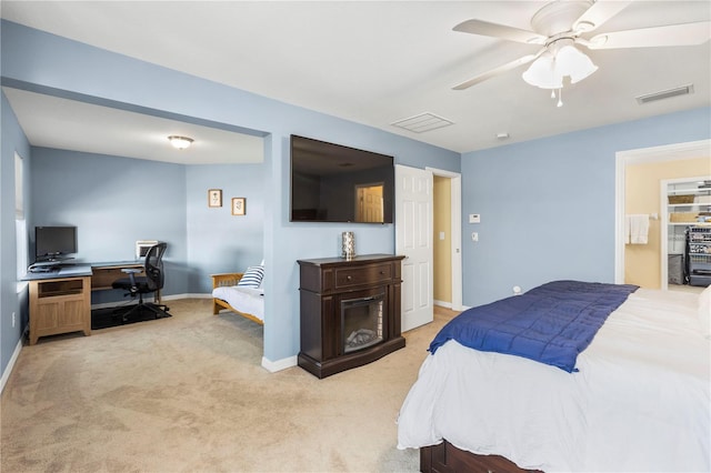 bedroom with baseboards, visible vents, a ceiling fan, and light colored carpet