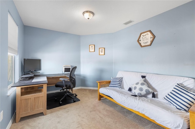 office area with light carpet, visible vents, and baseboards