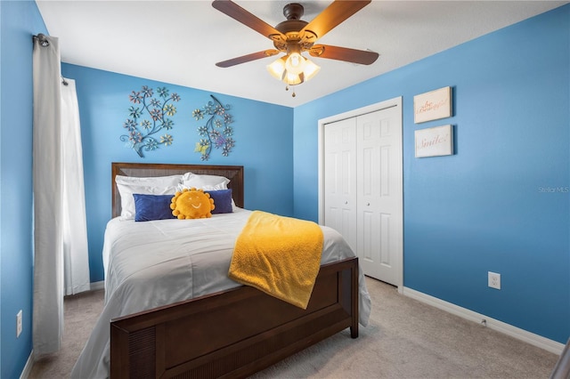 bedroom featuring ceiling fan, a closet, carpet flooring, and baseboards