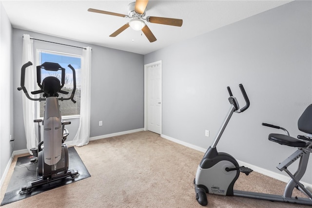 exercise room featuring carpet floors, ceiling fan, and baseboards