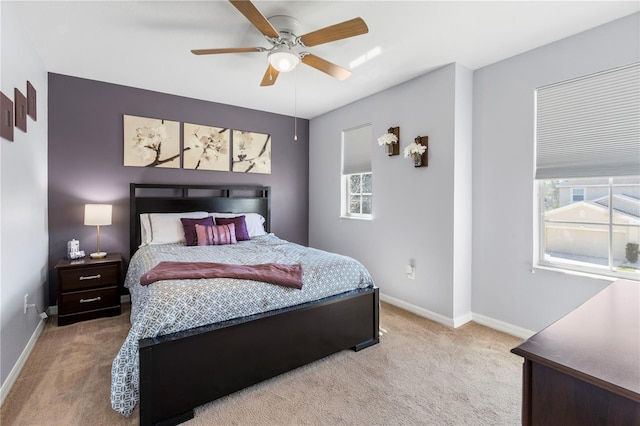 carpeted bedroom featuring baseboards and a ceiling fan