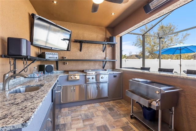 view of patio with area for grilling, glass enclosure, exterior kitchen, outdoor wet bar, and a sink