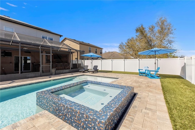 view of swimming pool with a patio, a yard, a fenced backyard, and a pool with connected hot tub