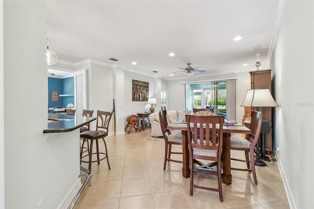 dining room with light tile patterned floors, visible vents, crown molding, and recessed lighting