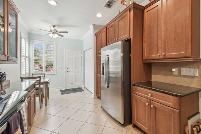 kitchen featuring ornamental molding, brown cabinets, visible vents, and stainless steel fridge with ice dispenser