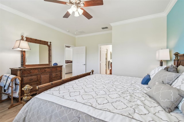 bedroom with ornamental molding, a ceiling fan, visible vents, and wood finished floors