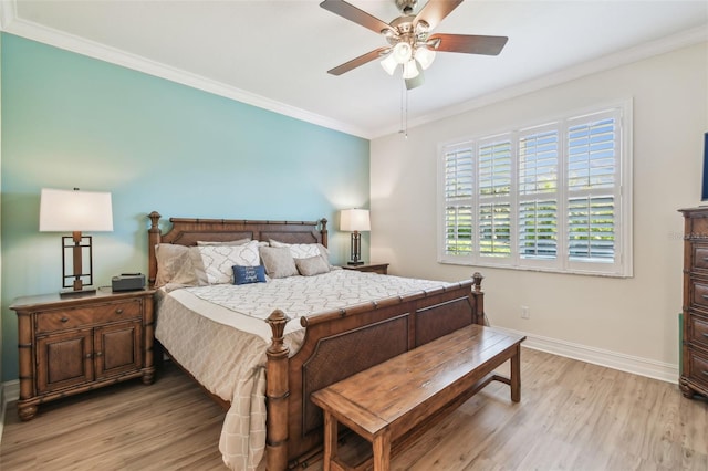 bedroom with baseboards, a ceiling fan, light wood-style flooring, and crown molding