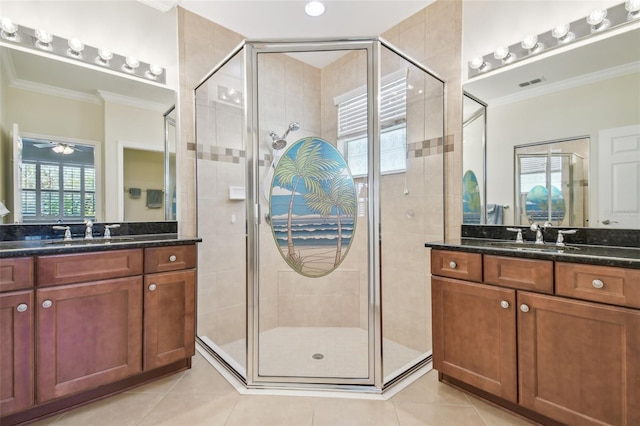 bathroom featuring a stall shower, crown molding, visible vents, and a sink