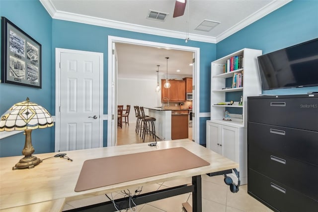 home office with light tile patterned floors, ornamental molding, visible vents, and a ceiling fan