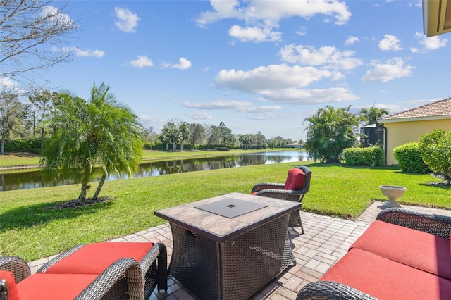 view of patio with a water view and an outdoor living space