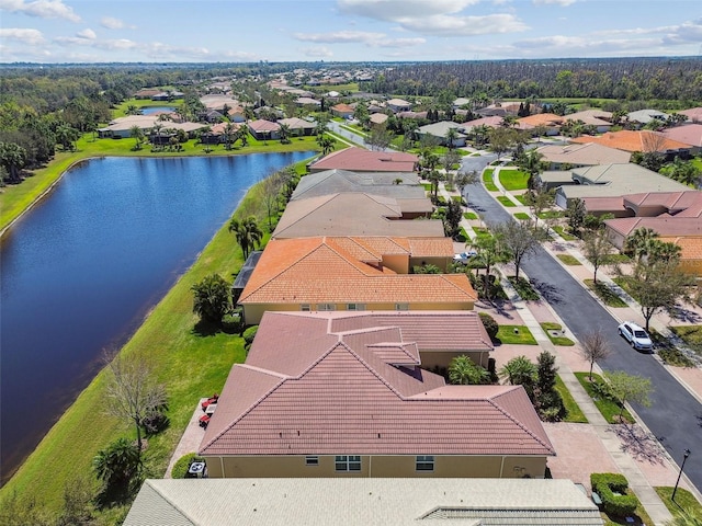 drone / aerial view featuring a residential view and a water view