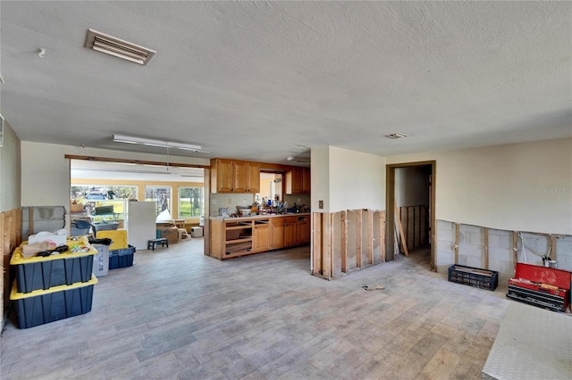 kitchen featuring light countertops, light wood-type flooring, and visible vents