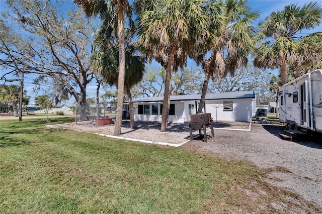 rear view of property with a yard