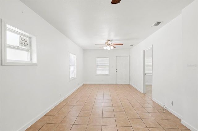 spare room featuring plenty of natural light, visible vents, and a ceiling fan