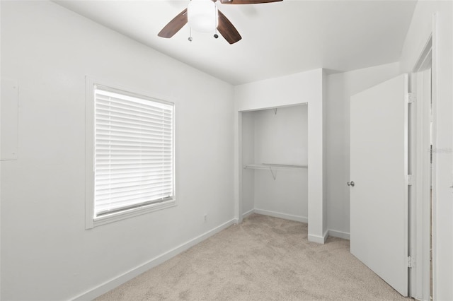 unfurnished bedroom featuring carpet floors, a closet, a ceiling fan, and baseboards