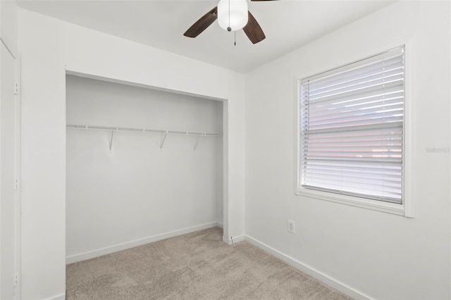 unfurnished bedroom with light carpet, multiple windows, a closet, and baseboards