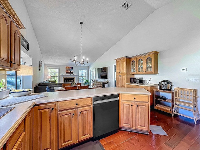 kitchen featuring lofted ceiling, open floor plan, light countertops, dark wood finished floors, and glass insert cabinets