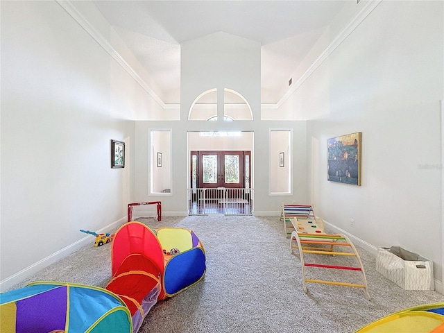 recreation room with high vaulted ceiling, carpet, and baseboards