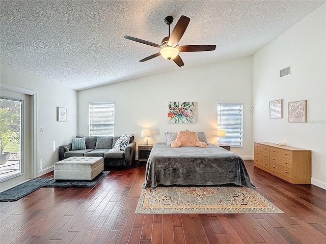 bedroom featuring lofted ceiling, multiple windows, and hardwood / wood-style flooring