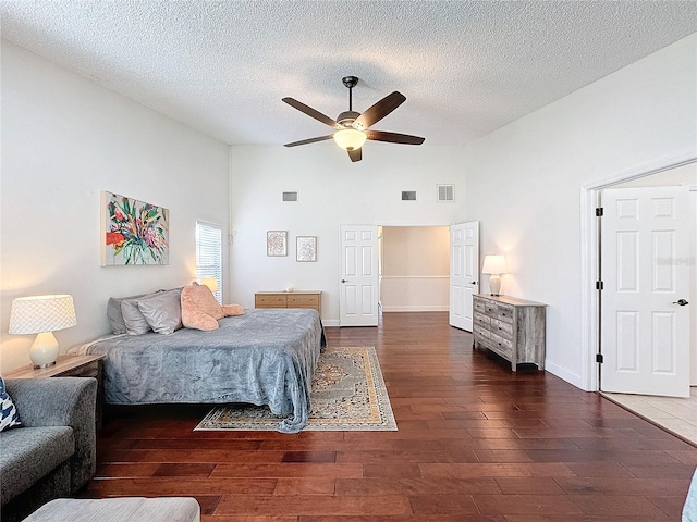 bedroom featuring lofted ceiling, visible vents, and wood finished floors