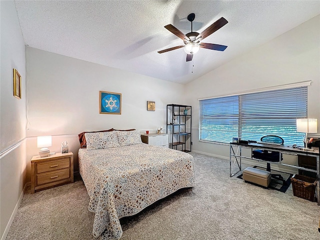 bedroom with lofted ceiling, ceiling fan, a textured ceiling, carpet flooring, and baseboards