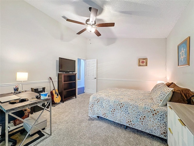 bedroom with visible vents, a ceiling fan, carpet flooring, vaulted ceiling, and a textured ceiling