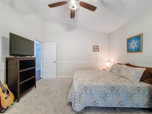 carpeted bedroom with a ceiling fan, lofted ceiling, a textured ceiling, and baseboards