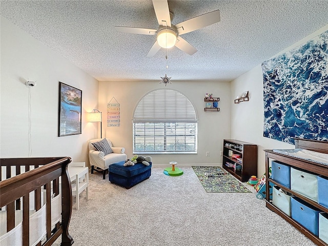 bedroom with carpet floors, ceiling fan, and a textured ceiling