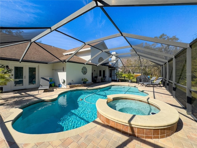 view of pool featuring glass enclosure, french doors, a patio area, and a pool with connected hot tub