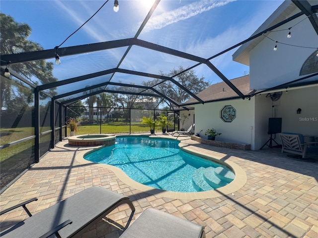 view of swimming pool featuring a patio area, a lanai, and a pool with connected hot tub