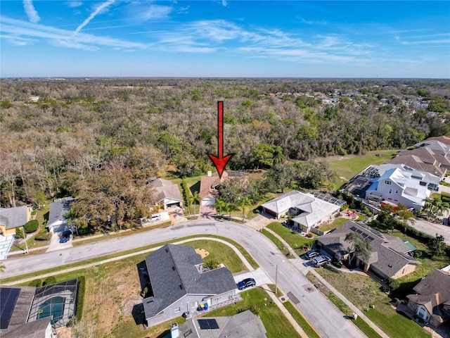 drone / aerial view with a residential view and a view of trees