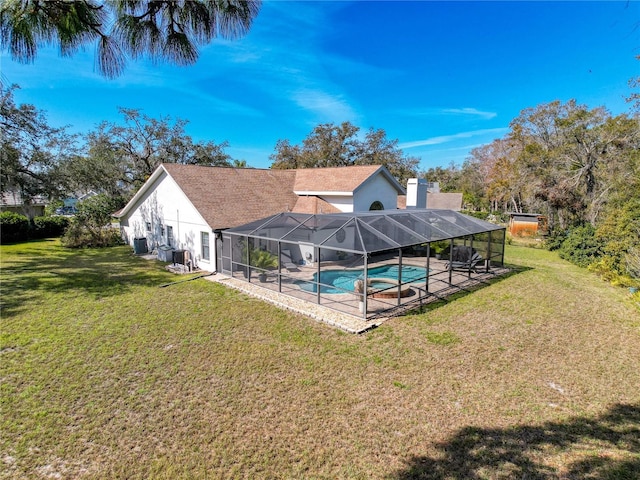 pool with central AC unit, a lawn, a patio area, and a lanai