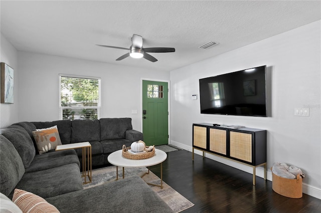 living room featuring wood finished floors, baseboards, and ceiling fan