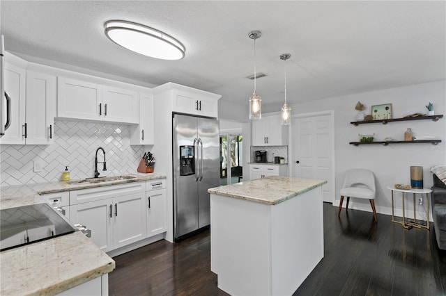 kitchen with stainless steel fridge with ice dispenser, a sink, decorative backsplash, dark wood-type flooring, and white cabinetry