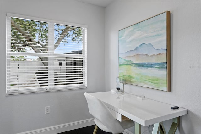 dining area featuring baseboards