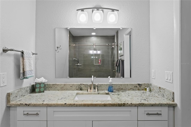 full bath featuring vanity and a stall shower