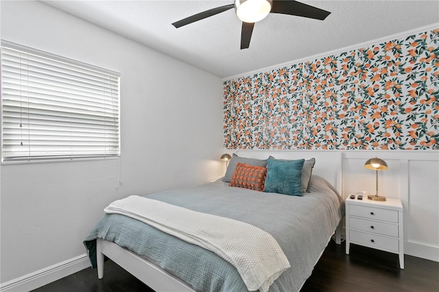 bedroom featuring a wainscoted wall, wood finished floors, and ceiling fan