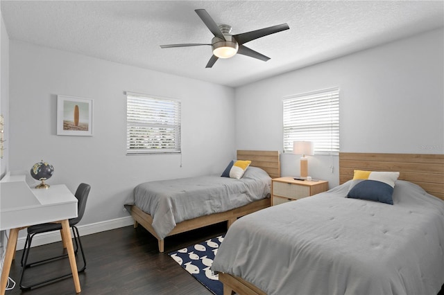 bedroom featuring dark wood finished floors, a textured ceiling, baseboards, and ceiling fan