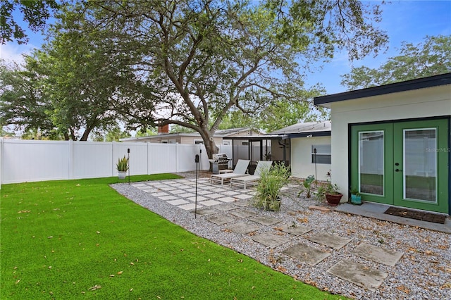 view of yard featuring french doors and a patio area