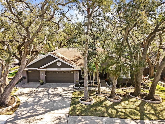 view of front of house with a garage, concrete driveway, and brick siding