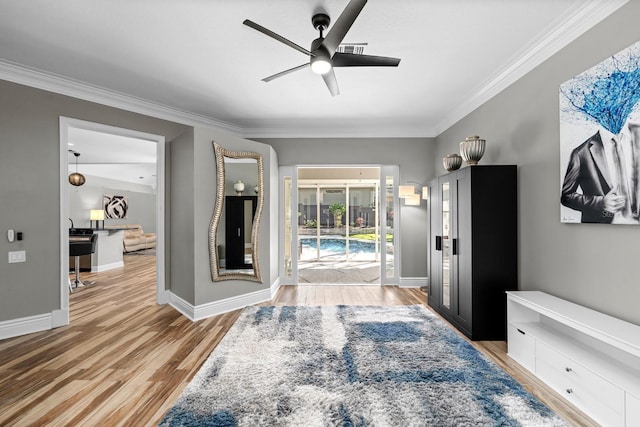 bedroom featuring access to exterior, light wood-style flooring, ornamental molding, ceiling fan, and baseboards