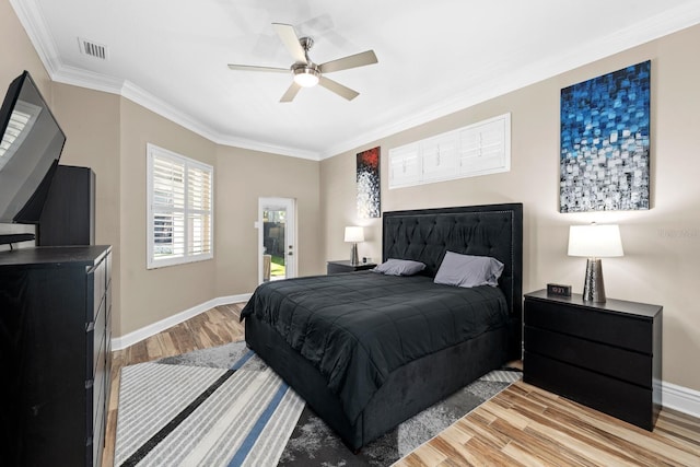 bedroom with light wood-style flooring, a ceiling fan, baseboards, visible vents, and crown molding