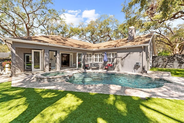 rear view of property with a yard, a patio area, fence, and stucco siding