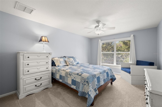 carpeted bedroom featuring visible vents, ceiling fan, and baseboards