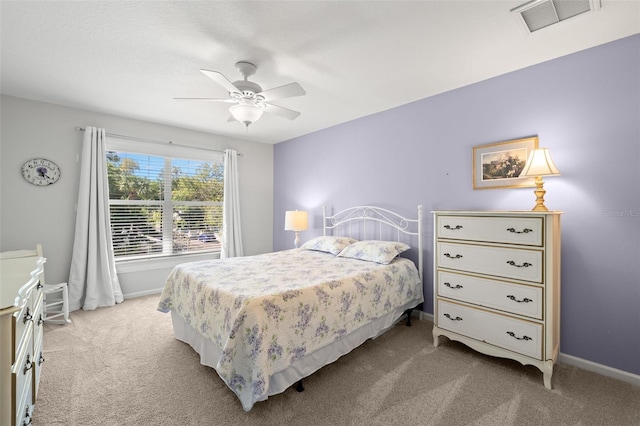 carpeted bedroom with baseboards, visible vents, and ceiling fan