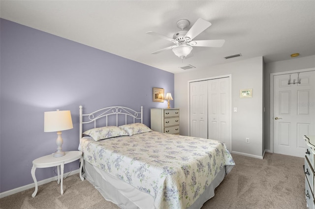 carpeted bedroom with baseboards, visible vents, ceiling fan, and a closet