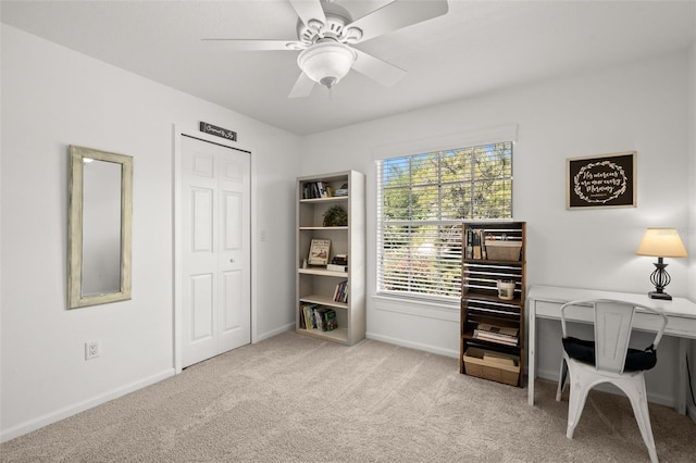 office with light carpet, baseboards, and a ceiling fan