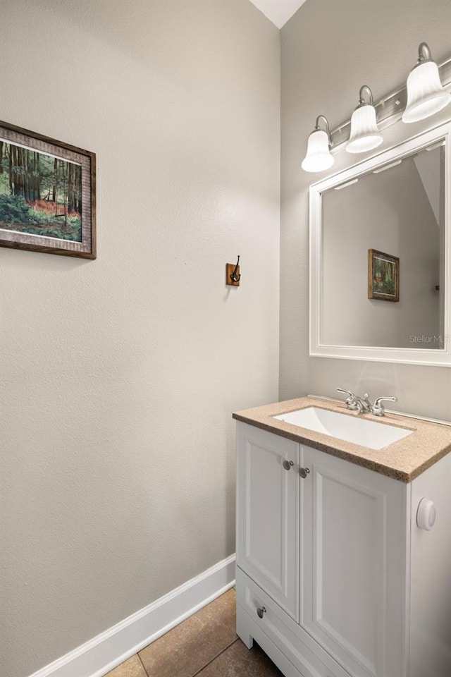 bathroom featuring tile patterned floors, baseboards, and vanity