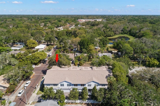 drone / aerial view featuring a forest view