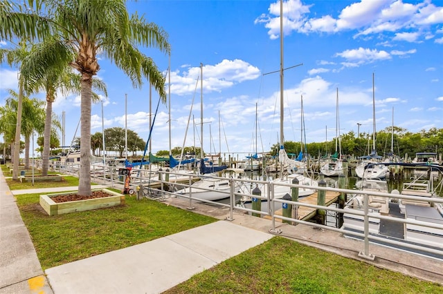 view of dock featuring a yard and a water view